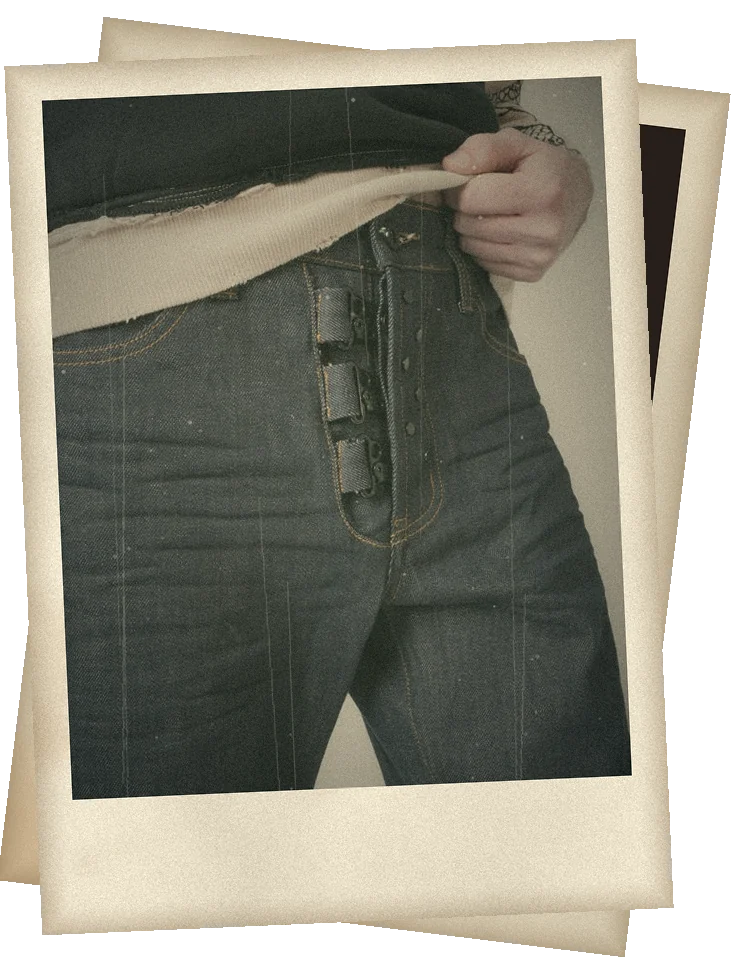Exposed hardware button fly on raw denim